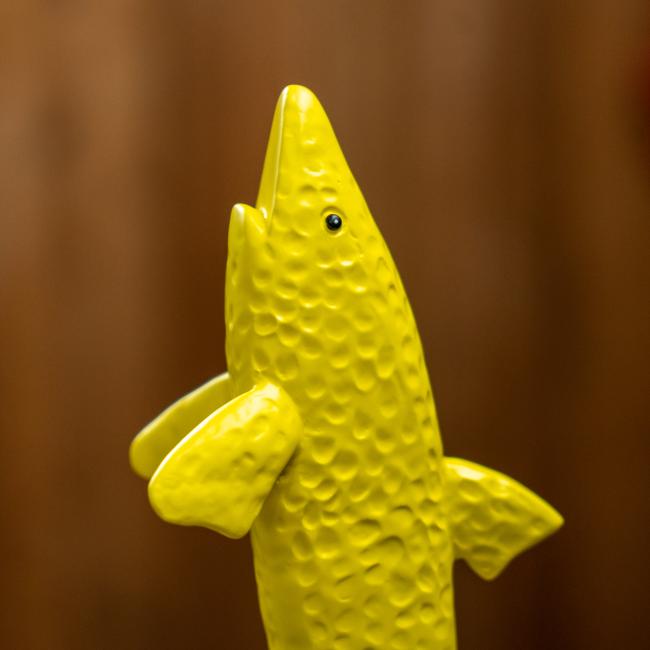 Close-up of shark on tap handle.