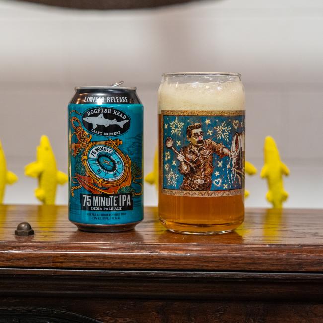Front view of glass with Jon Langford artwork next to 75 Minute IPA can.