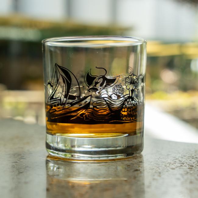View of water themed artwork around the glass in black.