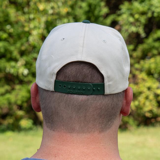Back of hat showing green snapback strap.