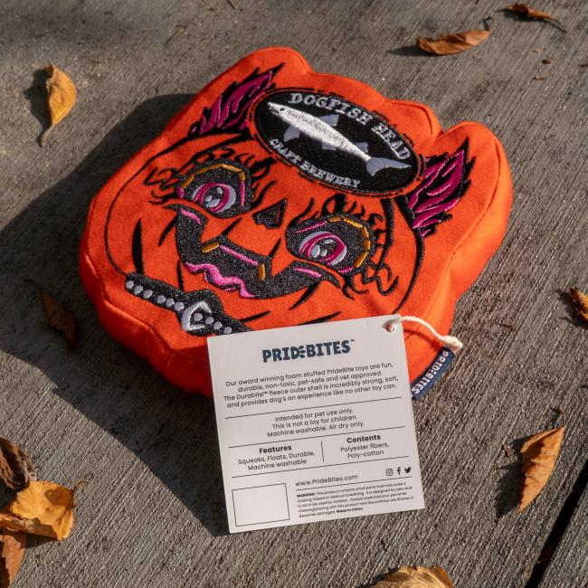 Image features the tag on the toy which includes brand details, fabric, and features.