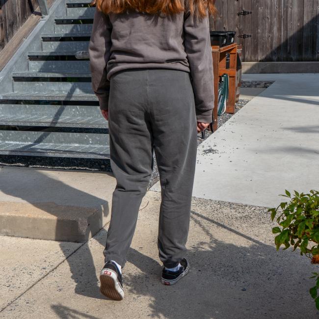 Back of grey sweatpants, being modeled, are solid grey.