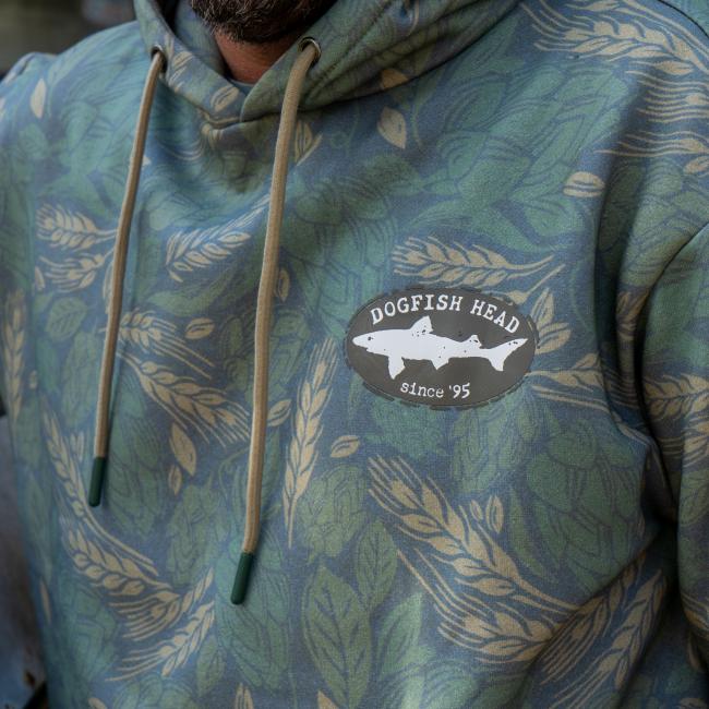 Close up of the black Dogfish Head shark and shield logo that is featured on the left side of the chest.