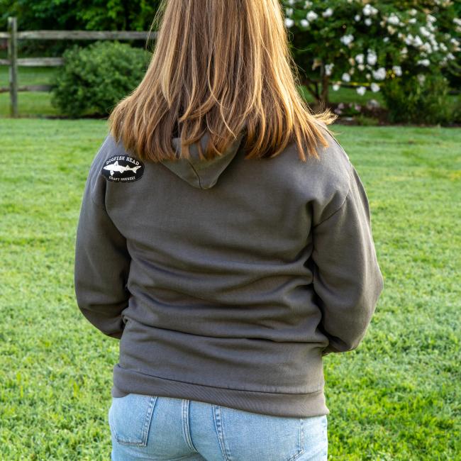 Back view of hoodie featuring black and white shark and shield Dogfish Head logo on top left.