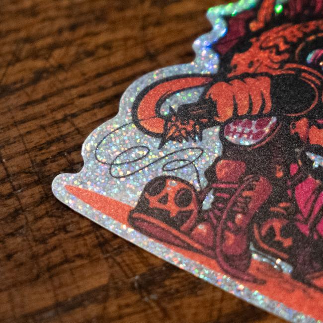Sticker features orange/red Punkin artwork with a mic in its hand. Sticker is outlined with glitter.