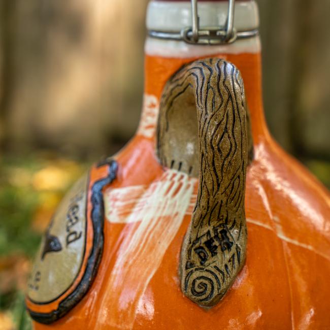 Close-up of the growler handle which is brown made to look like a tree branch.